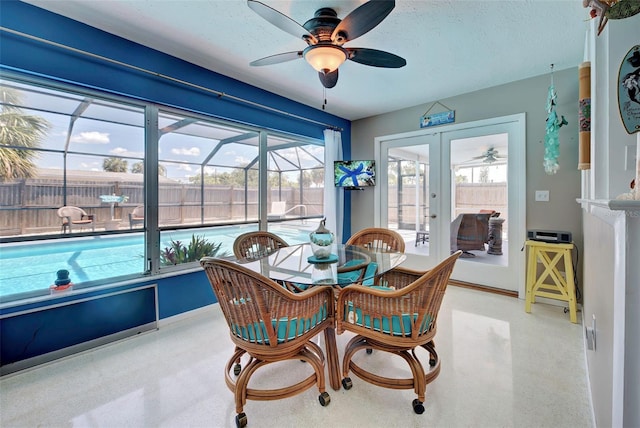 sunroom with french doors, plenty of natural light, and ceiling fan