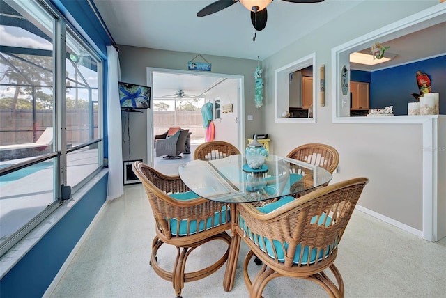 carpeted dining space with ceiling fan and a healthy amount of sunlight