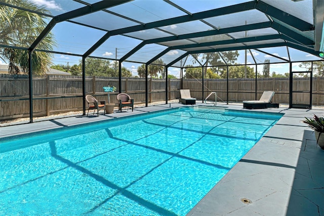 view of pool with a lanai and a patio