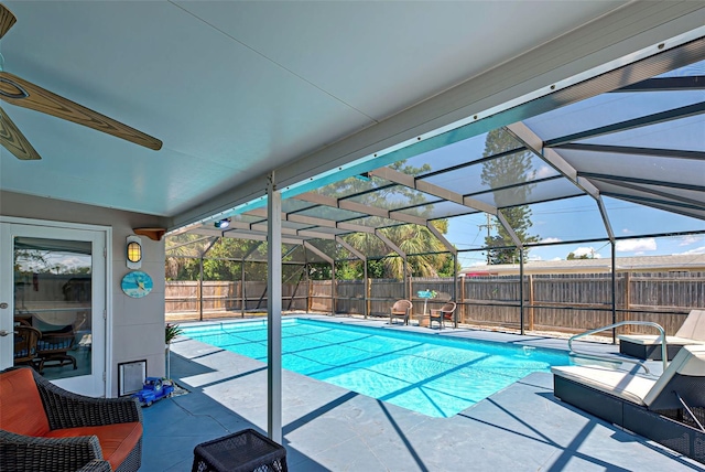 view of swimming pool with glass enclosure and a patio area