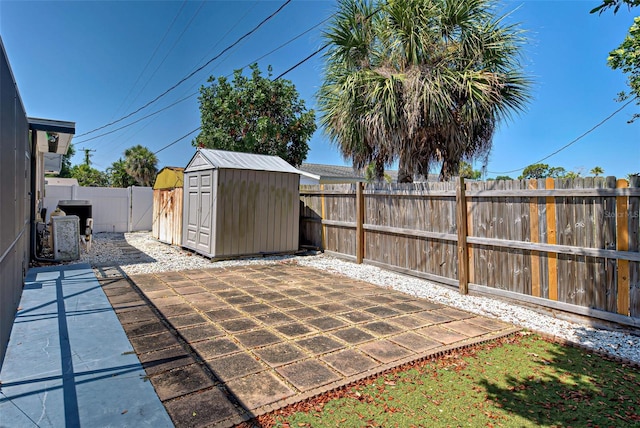 view of patio with cooling unit and a storage shed