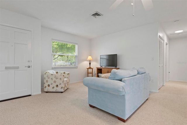 carpeted living room featuring ceiling fan