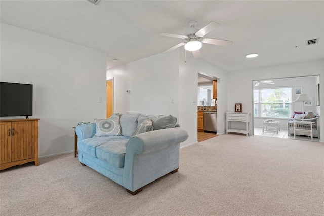 living room with light hardwood / wood-style floors and ceiling fan