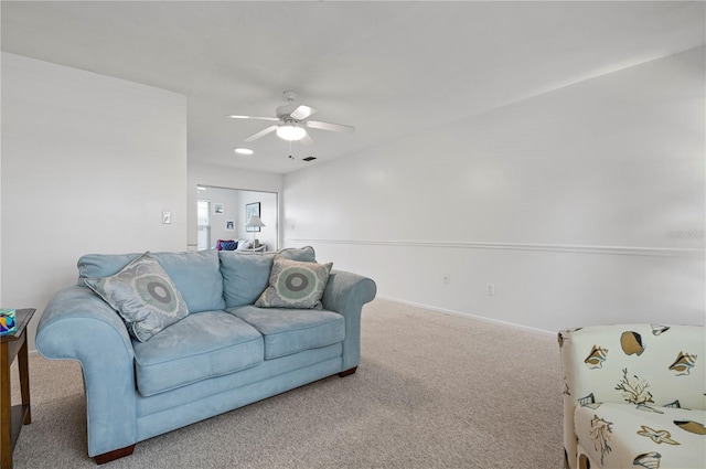 carpeted living room with ceiling fan