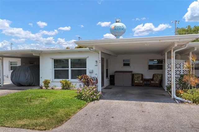 manufactured / mobile home with a front yard and a carport