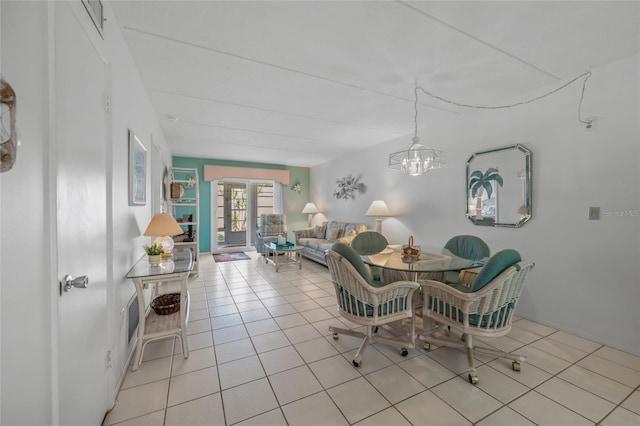 tiled dining room featuring a chandelier