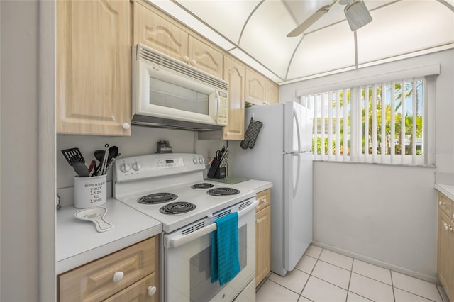 kitchen with ceiling fan, light brown cabinetry, light tile patterned floors, and white appliances