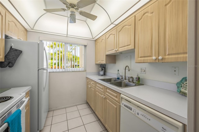 kitchen with light brown cabinetry, light tile patterned flooring, white appliances, and sink