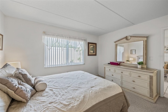 bedroom featuring light colored carpet