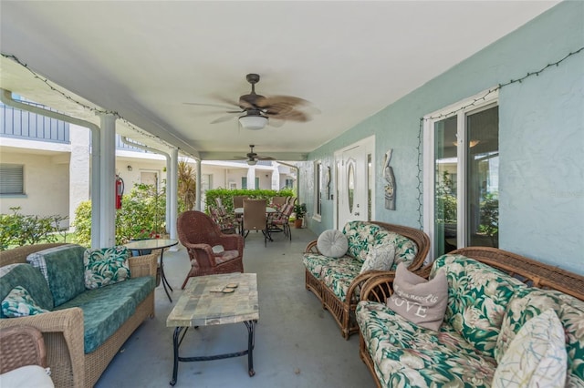 sunroom / solarium featuring ceiling fan and a healthy amount of sunlight