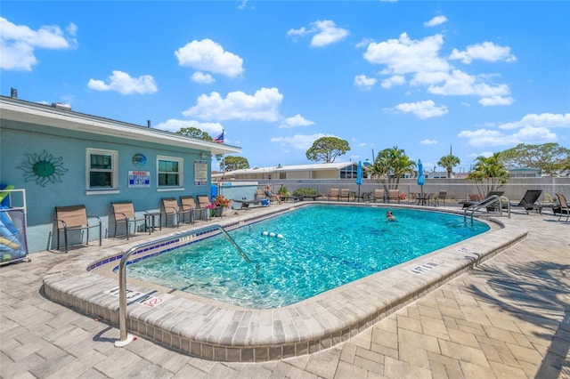 view of swimming pool with a patio