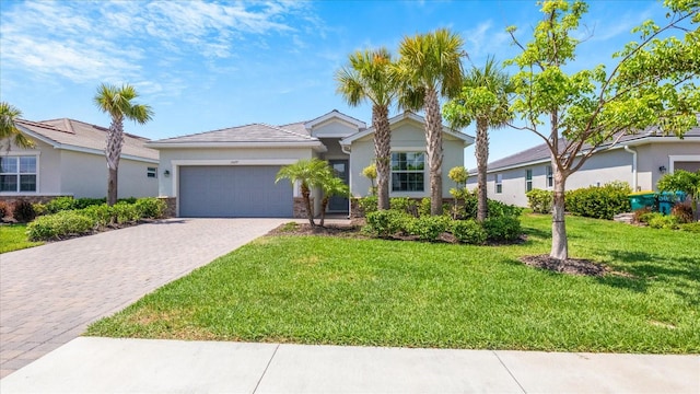 view of front of house featuring a garage and a front yard