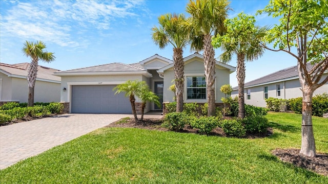 view of front of home with a front lawn and a garage