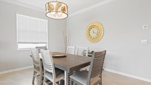 dining room featuring ornamental molding and light tile flooring