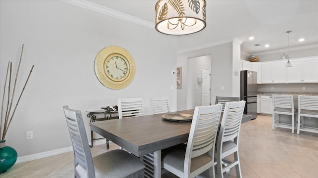 dining space with crown molding and light tile flooring