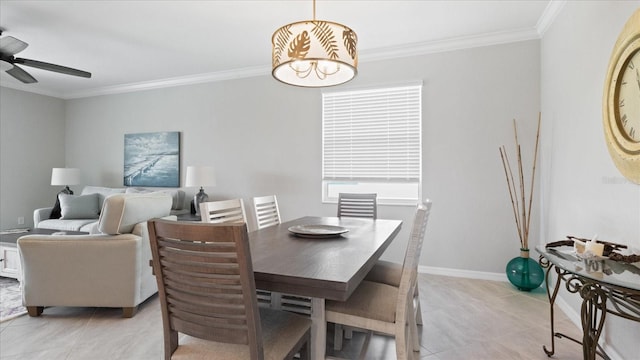 tiled dining area featuring ceiling fan and crown molding