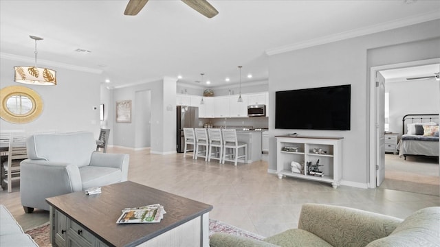 living room with ceiling fan, crown molding, and light tile floors