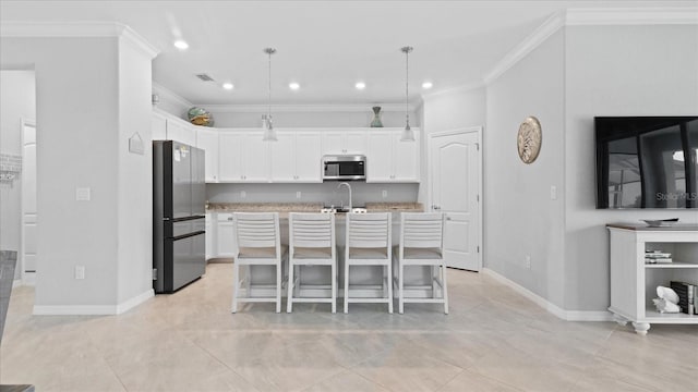 kitchen featuring an island with sink, light tile flooring, pendant lighting, and appliances with stainless steel finishes