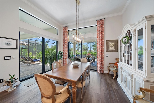 dining room with dark hardwood / wood-style flooring, crown molding, and a wealth of natural light