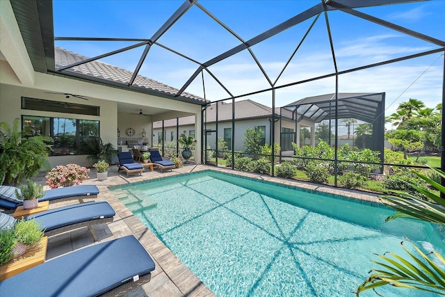 view of swimming pool with a lanai, a patio, and ceiling fan