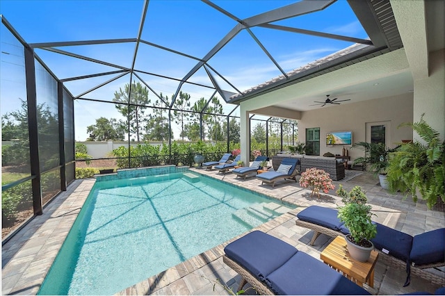 view of swimming pool featuring a patio area, ceiling fan, and glass enclosure