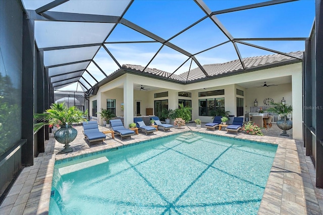 view of pool with a lanai, a patio, and ceiling fan