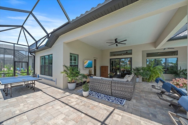 view of patio / terrace featuring an outdoor living space, a lanai, and ceiling fan