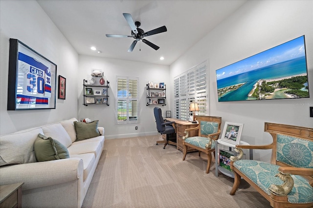 office space with light carpet and ceiling fan