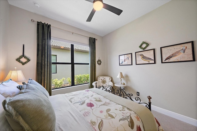 bedroom with ceiling fan, carpet flooring, and vaulted ceiling