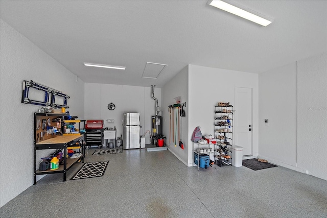 garage featuring stainless steel refrigerator and gas water heater