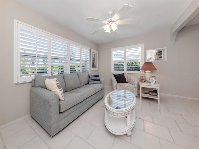 tiled living room featuring ceiling fan