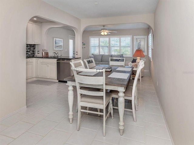 tiled dining space featuring ceiling fan