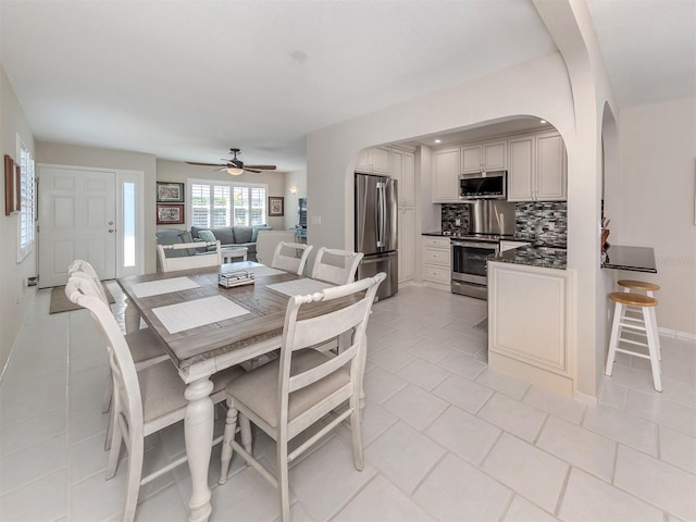 dining space featuring ceiling fan and light tile patterned flooring