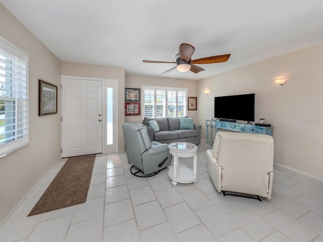 tiled living room with ceiling fan