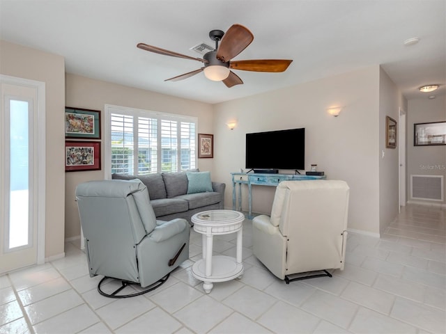 tiled living room featuring ceiling fan