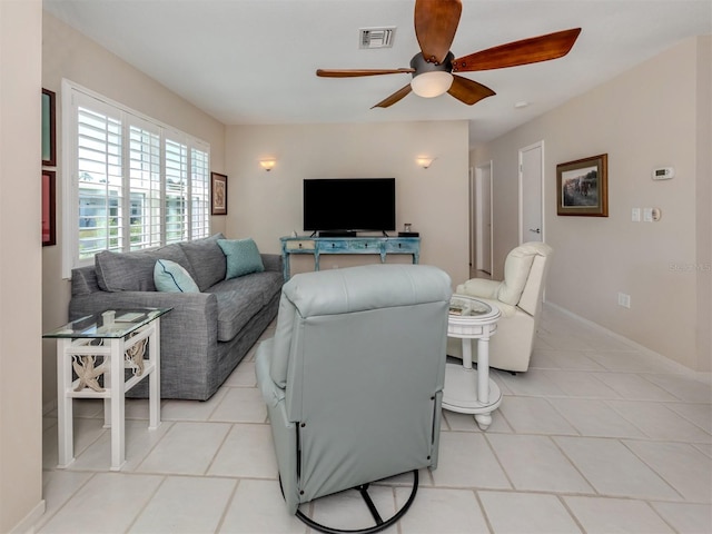 tiled living room with ceiling fan