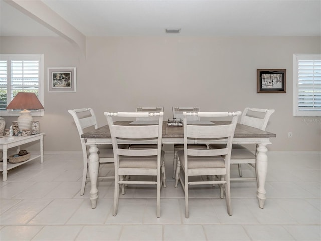 dining area featuring light tile patterned floors