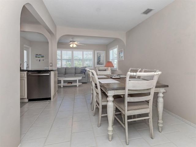 tiled dining room featuring ceiling fan