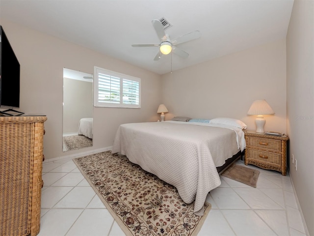 tiled bedroom featuring ceiling fan