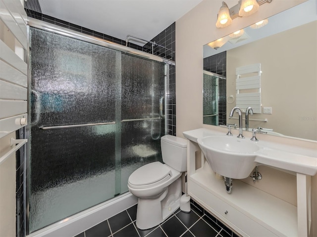 bathroom with toilet, tile patterned floors, and an enclosed shower