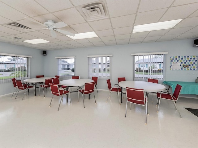 dining area featuring a paneled ceiling and ceiling fan