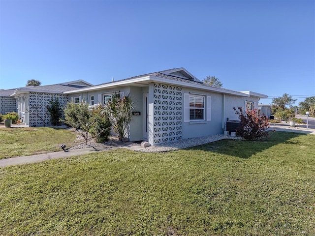 view of home's exterior with a lawn and cooling unit