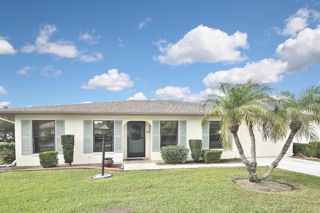 ranch-style house featuring a garage and a front lawn