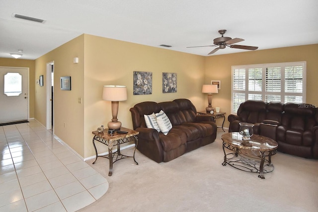 living room featuring ceiling fan and light tile patterned flooring