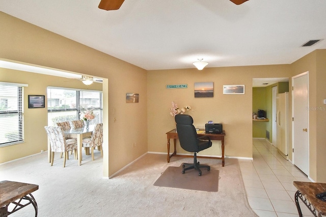 office area featuring light carpet and ceiling fan