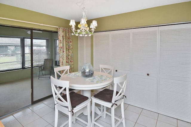 dining area featuring an inviting chandelier and light tile patterned flooring