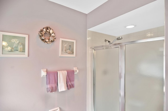 bathroom featuring a shower with shower door