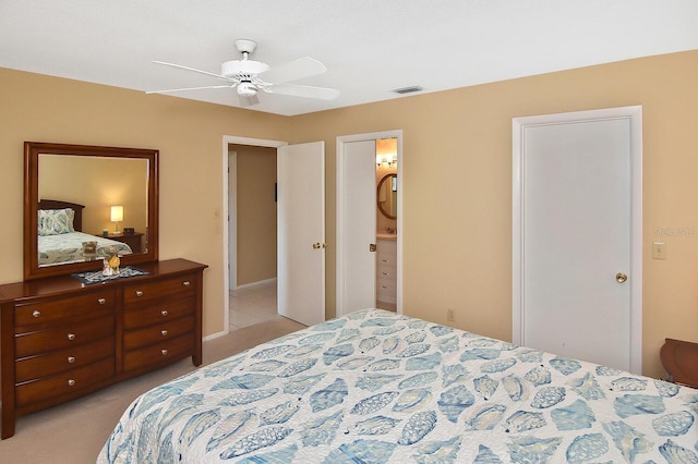 carpeted bedroom featuring ensuite bathroom and ceiling fan