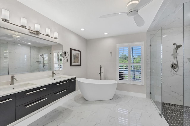 bathroom featuring ceiling fan, vanity, and independent shower and bath