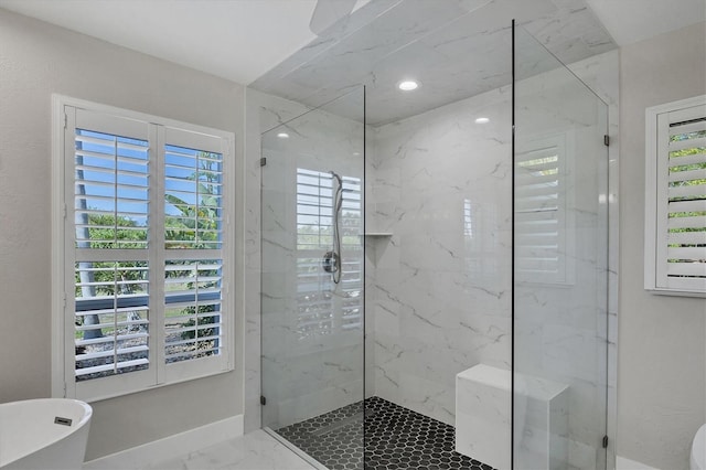 bathroom featuring a healthy amount of sunlight and shower with separate bathtub